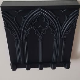 Decorative black  wall shelf with gothic design on a white background