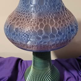 Decorative mushroom light with textured surface on a purple fabric background