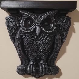 Decorative owl shelf bracket on a beige background