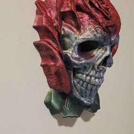 Decorative skull in rose head with red and blue colors on a plain background