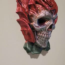 Decorative skull in rose head with red and gray colors on a plain background