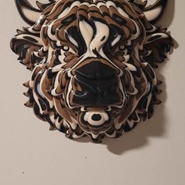 Decorative highlander cow head sculpture or mask on a beige wall